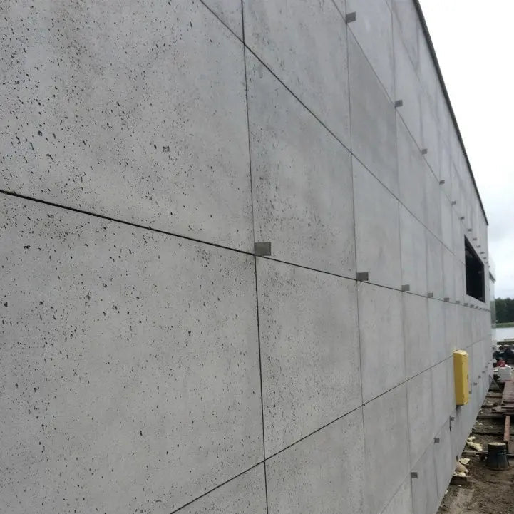 Concrete wall with construction materials in the background