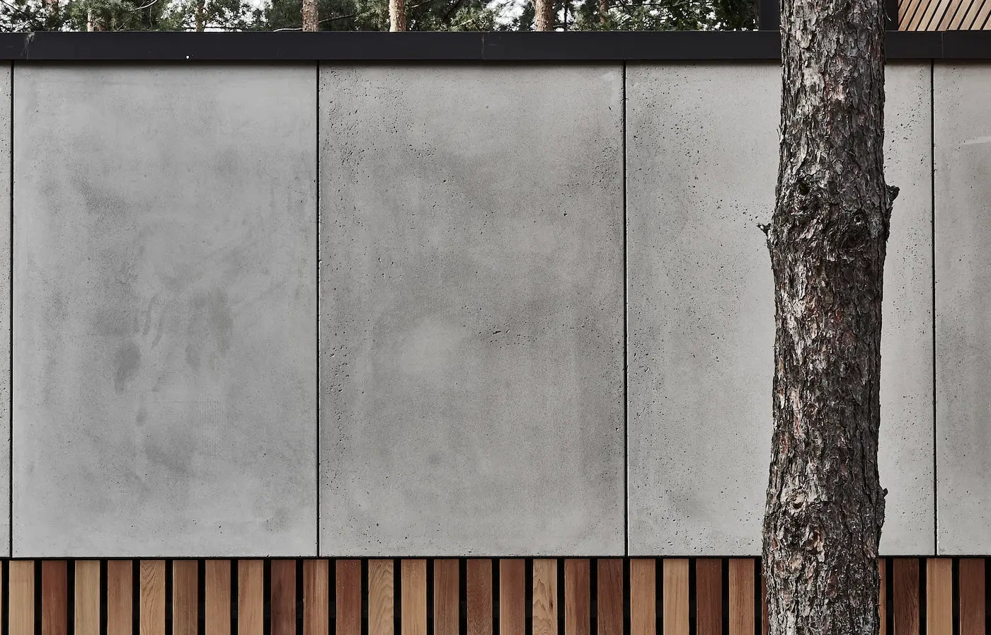 Architectural GRC concrete wall panels are used for the exterior cladding, complemented with a wooden base  | DecorMania UK
