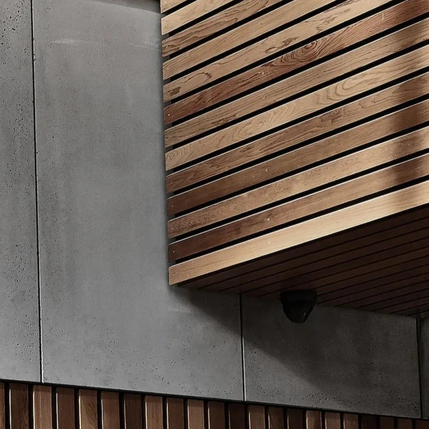 Architectural GRC concrete wall panels are used for the exterior cladding, complemented with a wooden base  | DecorMania UK