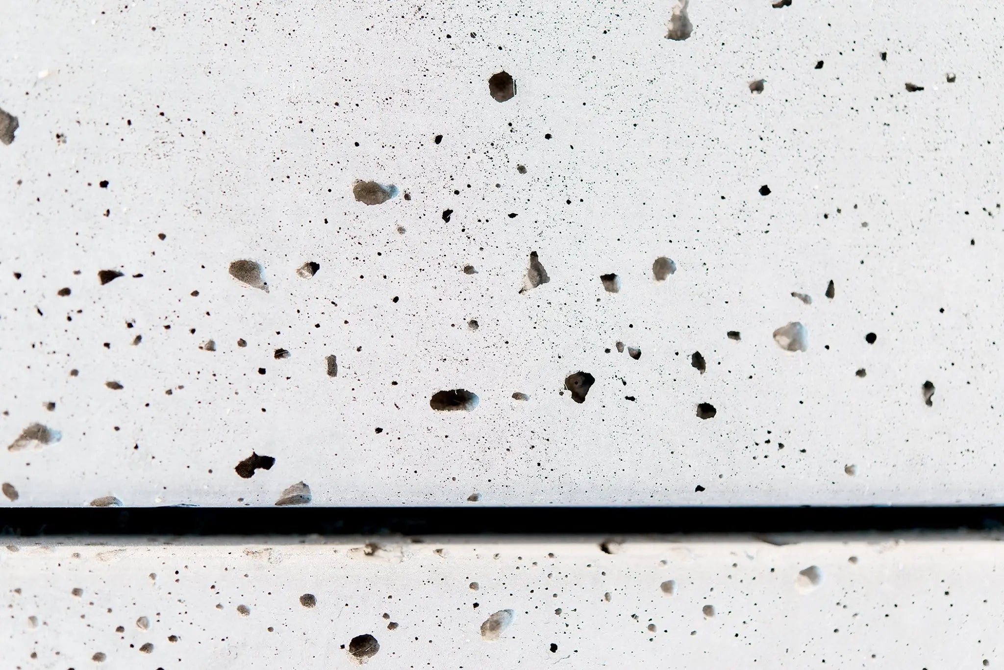Close-up of a concrete surface with a small shadow gap.
