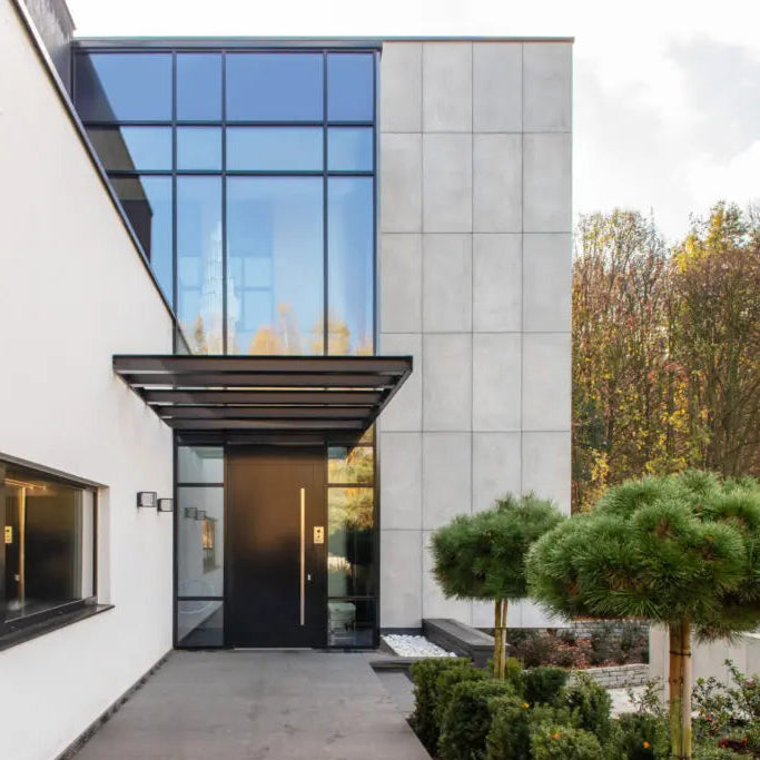 Modern house concrete exterior elevation with a glass door and surrounding greenery
