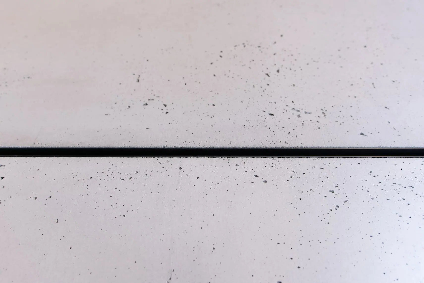 Close-up of a textured white surface with a black line running vertically.
