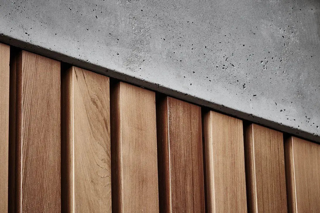 Close-up of wooden slats against a concrete wall