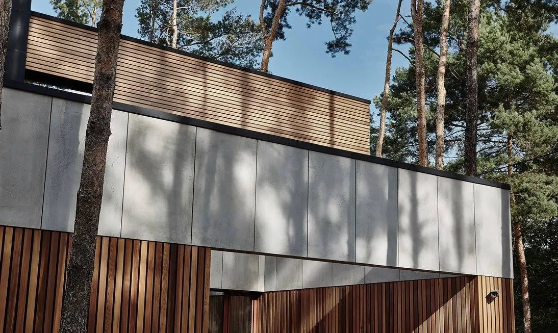 Modern building with wooden and concrete panels exterior in a forest setting