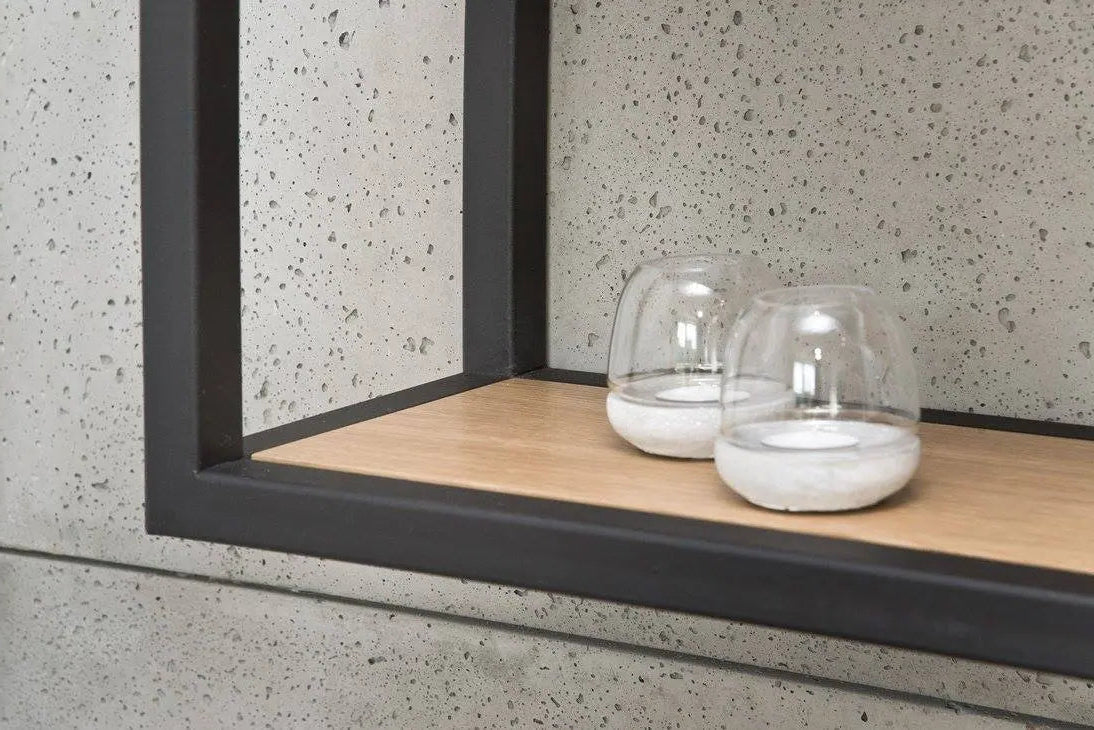 Two glass containers on a wooden shelf with a concrete wall background