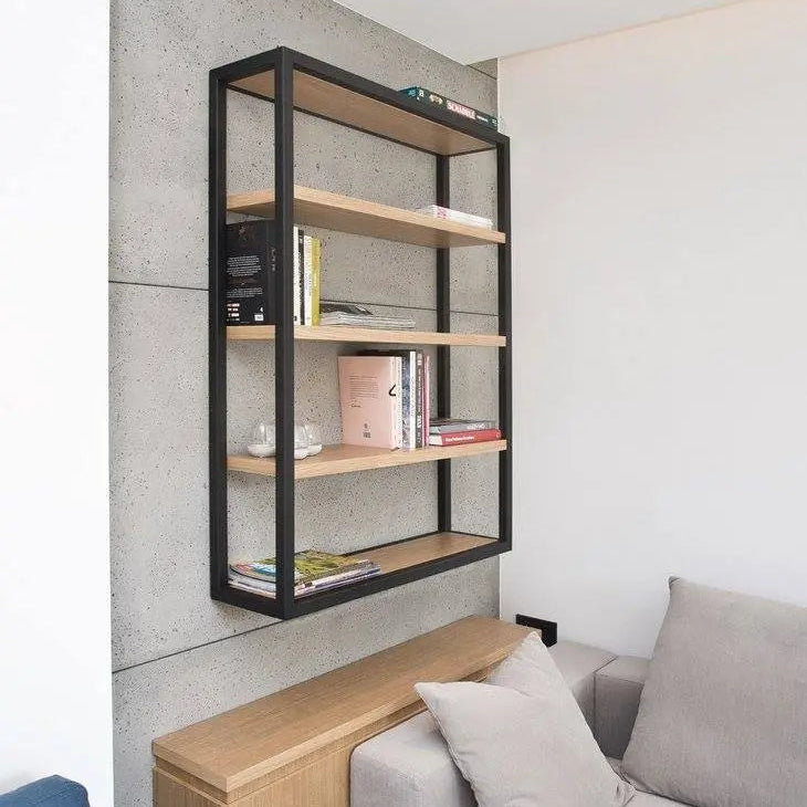 Modern interior with a bookshelf against a concrete wall next to a sofa.