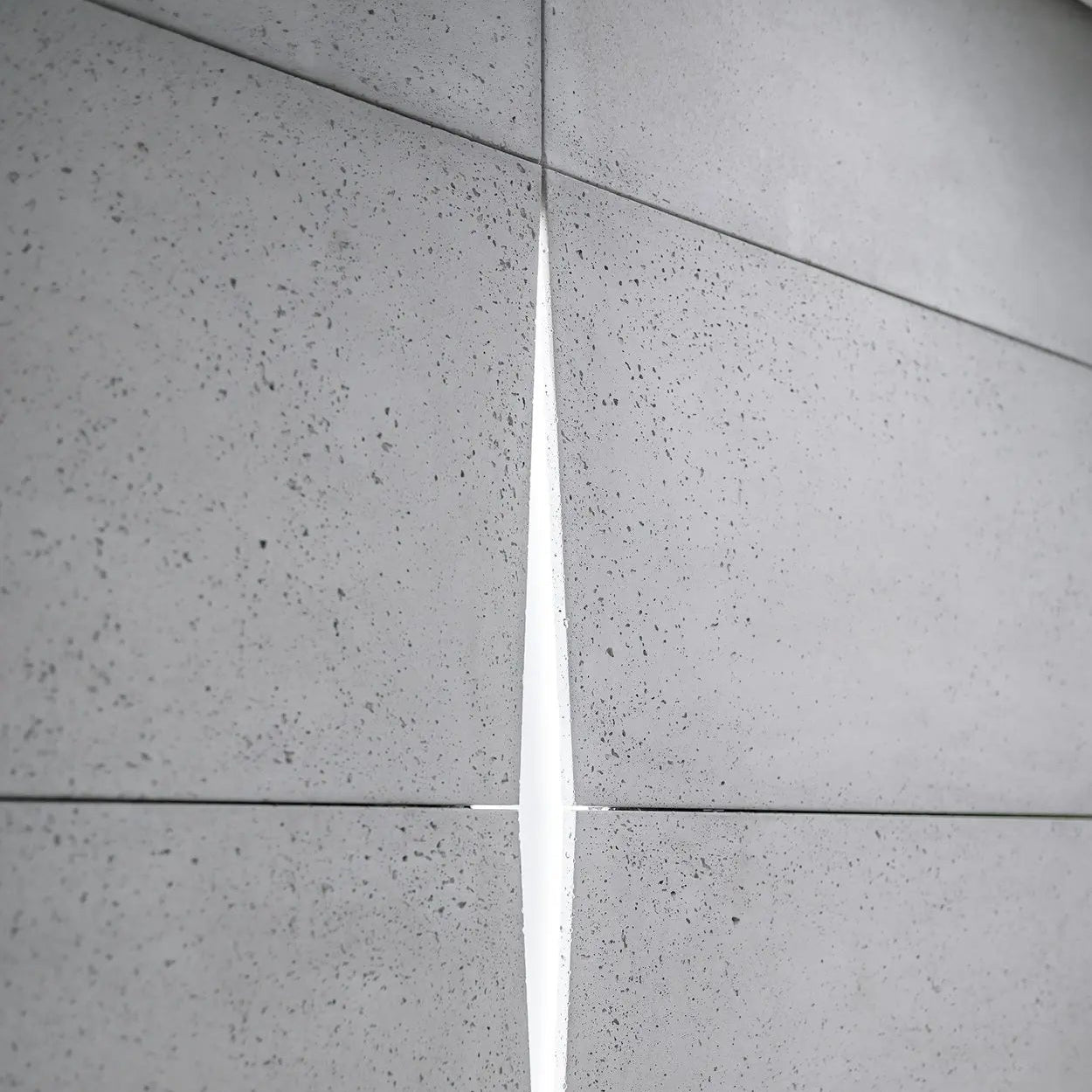 Close-up of grey concrete tiles with a visible grout line