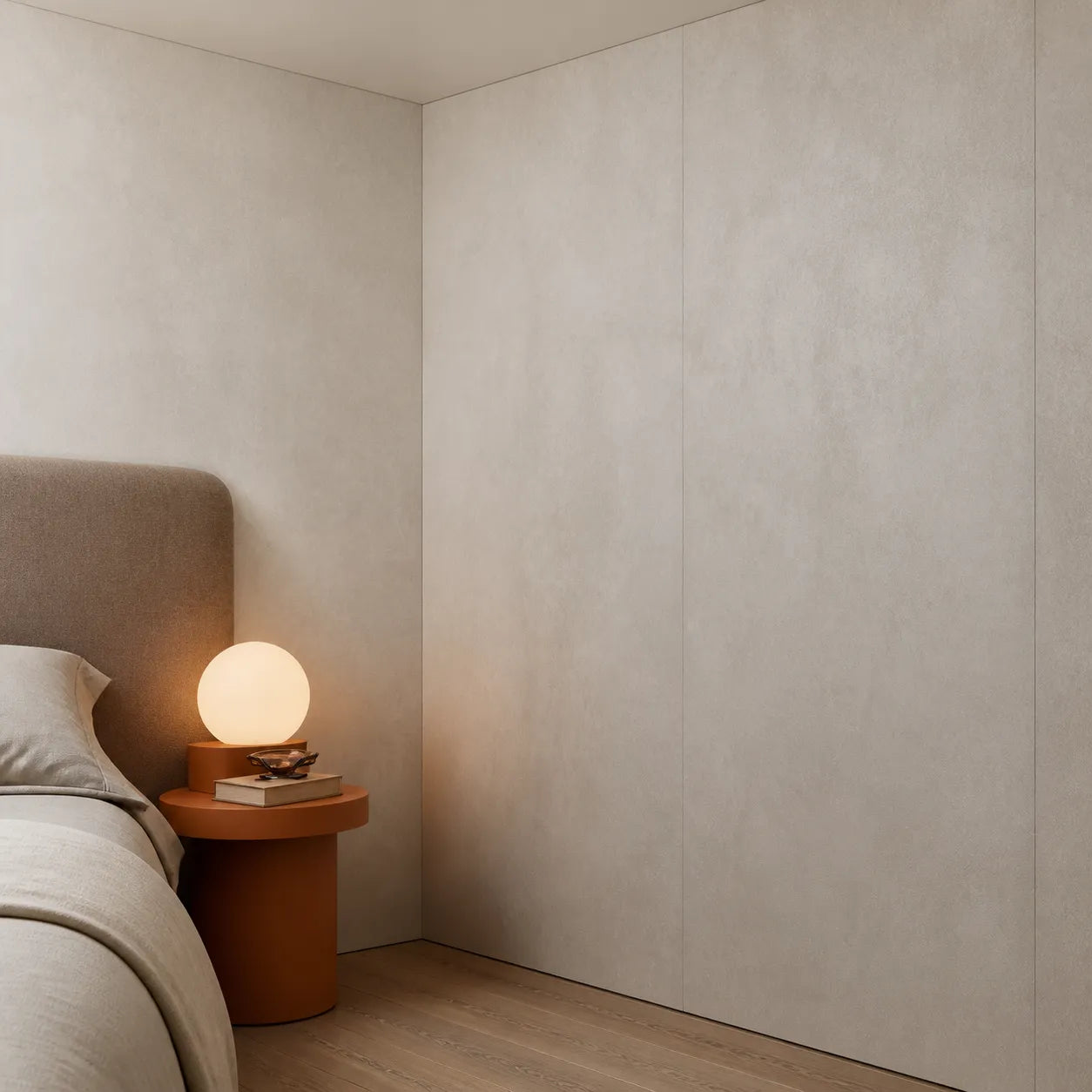 Close-up of Mineral Sand faux concrete wall panels in a softly lit modern bedroom