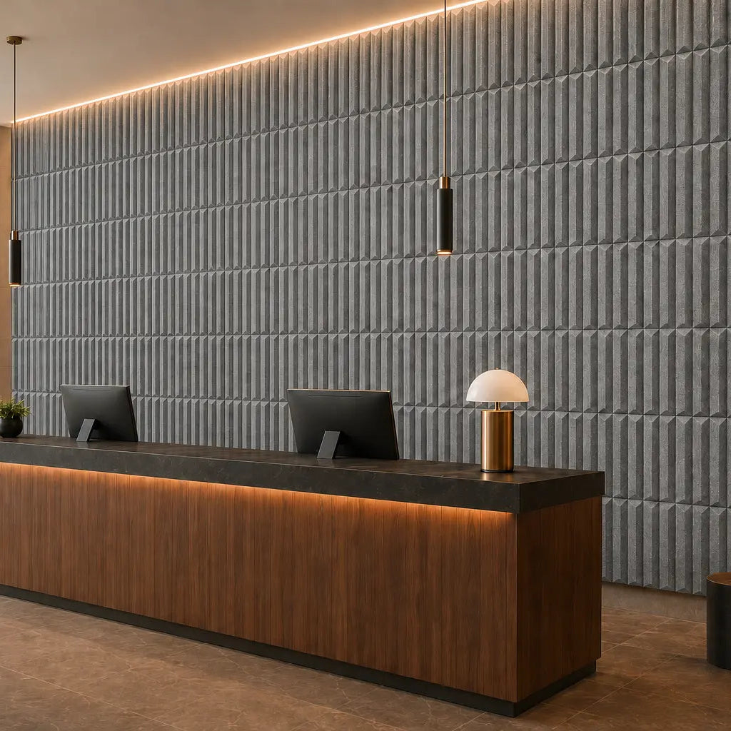 Modern reception viewed from the right at a 45-degree angle, with grey GROVE 3D acoustic felt wall panels and a wooden reception desk