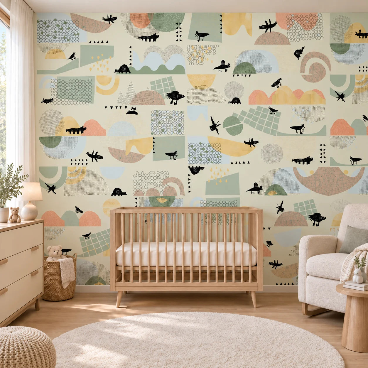 Front view of Juhu feature wall with pastel shapes and animal illustrations behind a wooden nursery cot