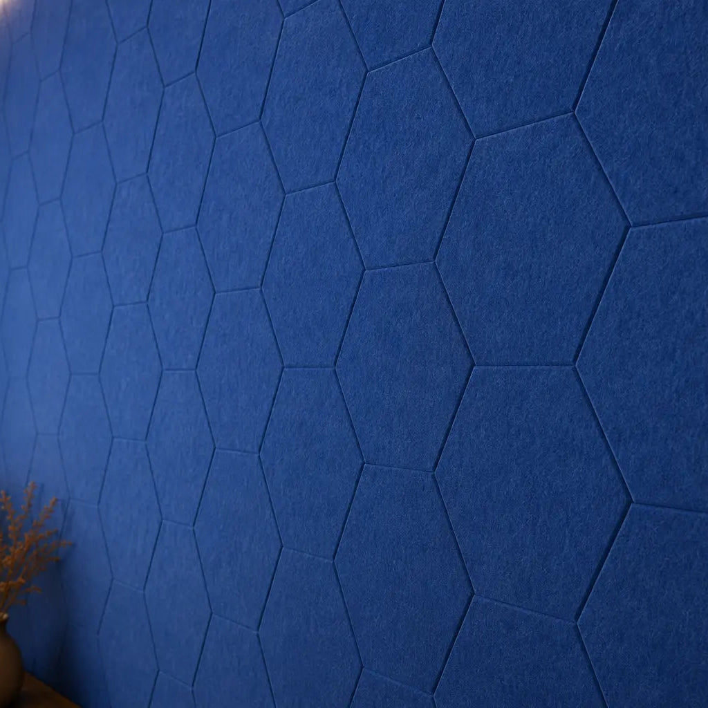 Dark blue HEXA 3D PET felt wall panel with a geometric hexagonal shape close up view
