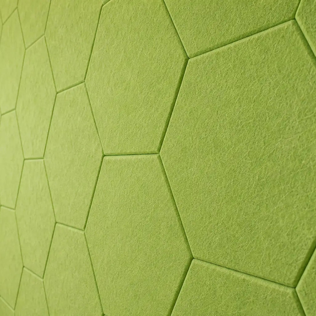 Green HEXA 3D felt PET wall panels in a cosy child’s bedroom with a wooden bed, study desk, storage unit and dog bed close up view