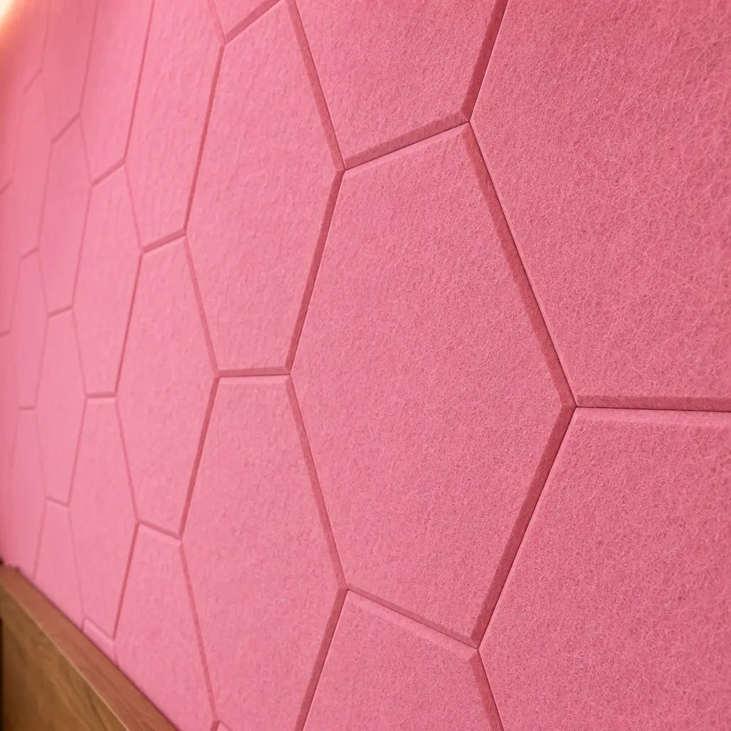 Pink HEXA 3D felt PET wall panels in a cosy child’s bedroom with a wooden bed, study desk, storage unit and dog bed close up view
