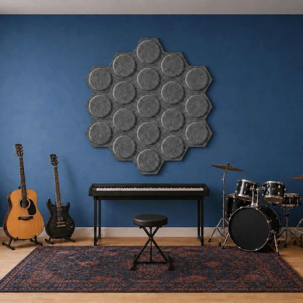Grey hexagonal 3D felt acoustic panels displayed above musical instruments on a blue wall