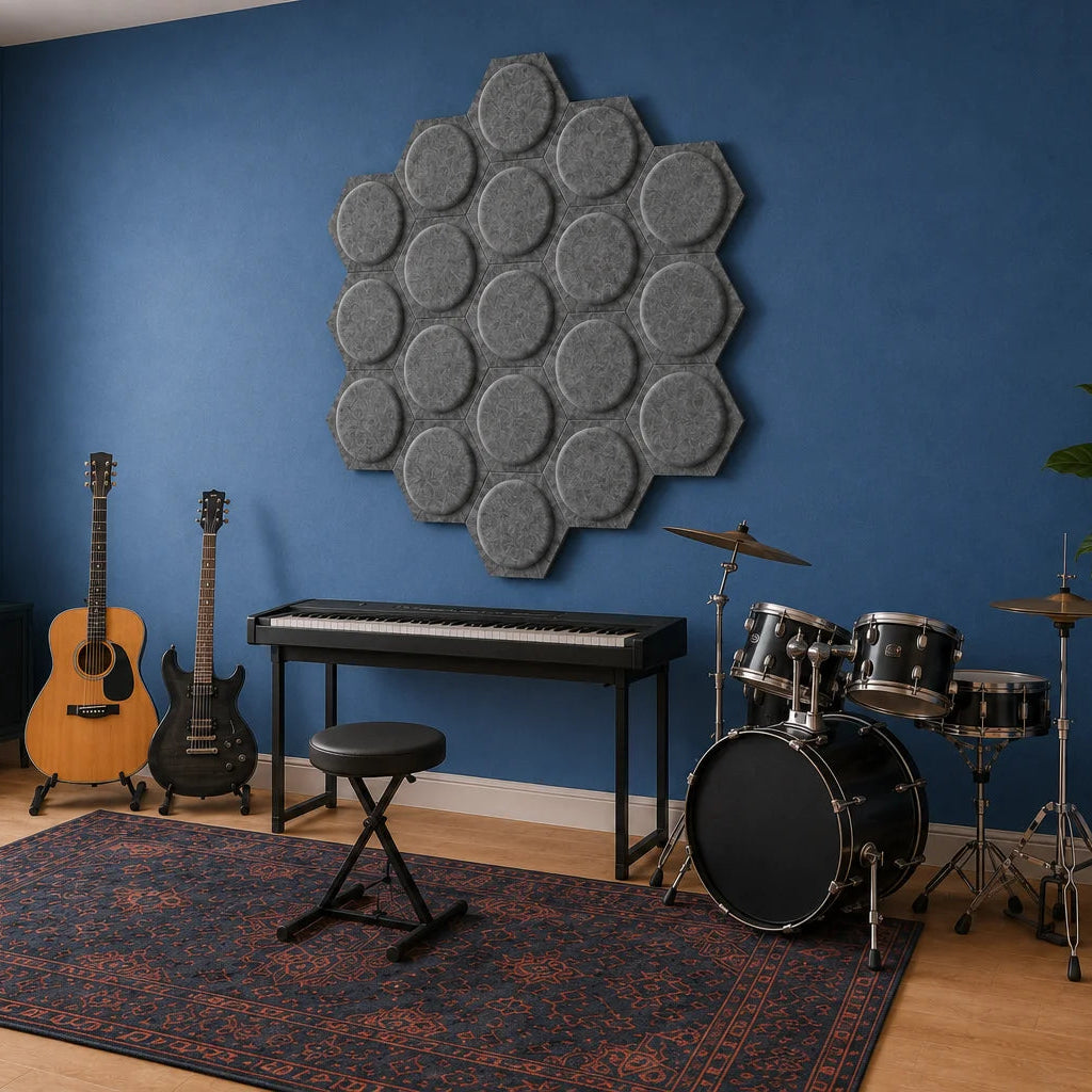 Angled view of grey hexagonal 3D acoustic panels in a music room with guitars, keyboard and drums