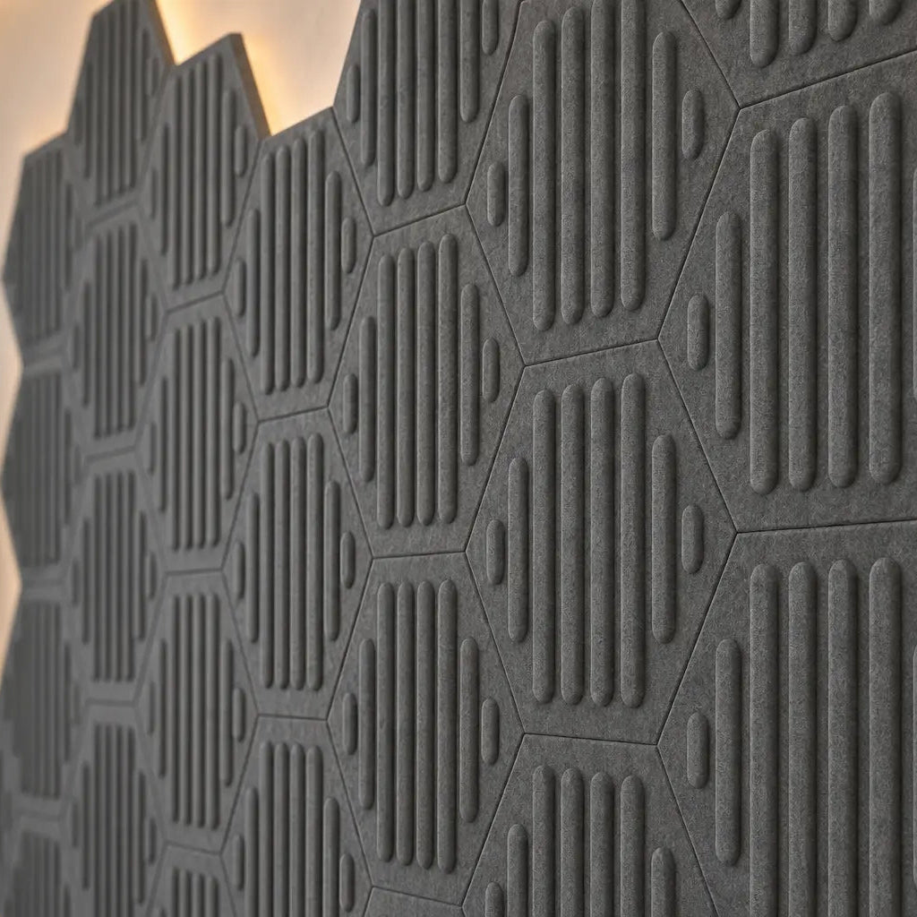 Close-up of grey HEXA RIFT 3D felt wall panels showing the raised pattern, joints and fibrous texture