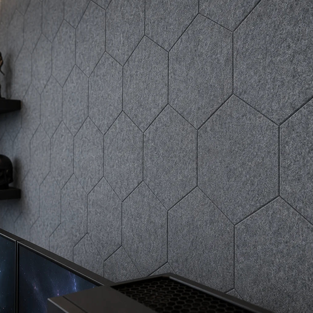Close-up of grey flat hexagonal felt panels showing precise joints and a dense fibrous texture