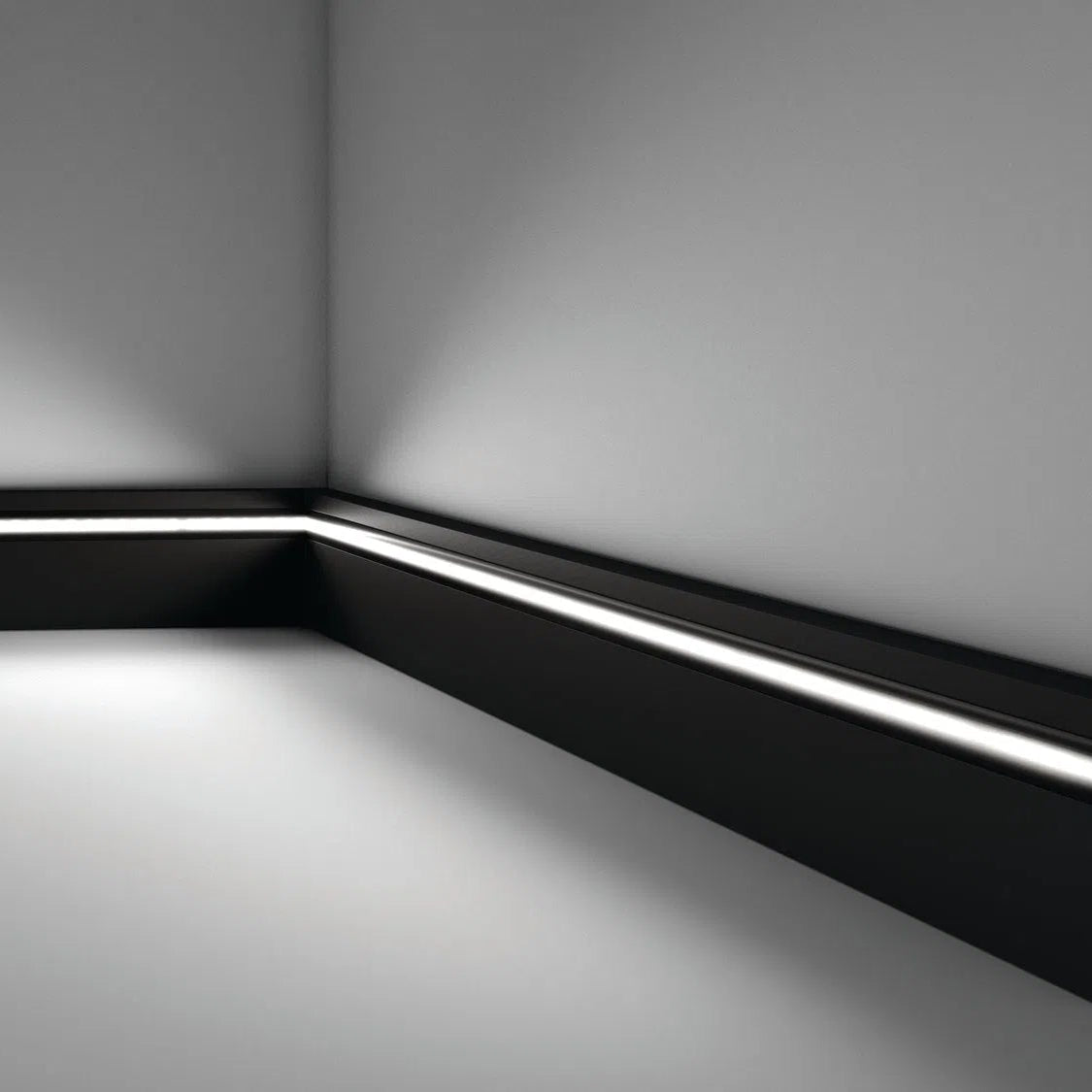 IL11 2M BLACK WALLSTYL SKIRTING BOARD - Skirtings with cable channel owner detail on a light-colored wall | DecorMania UK | DecorMania UK 