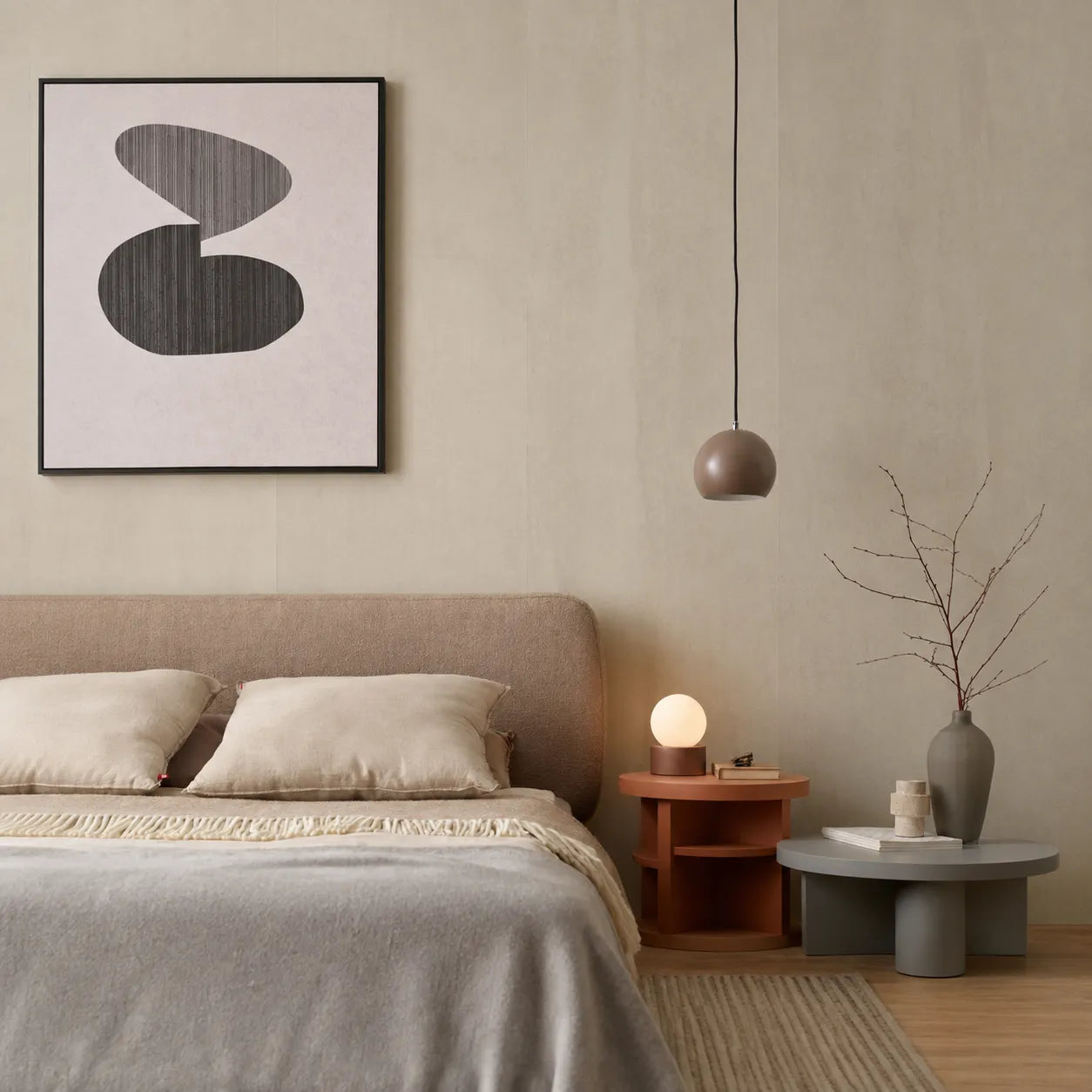 Mineral Sand faux concrete wall panels behind a modern upholstered bed with warm bedside lighting