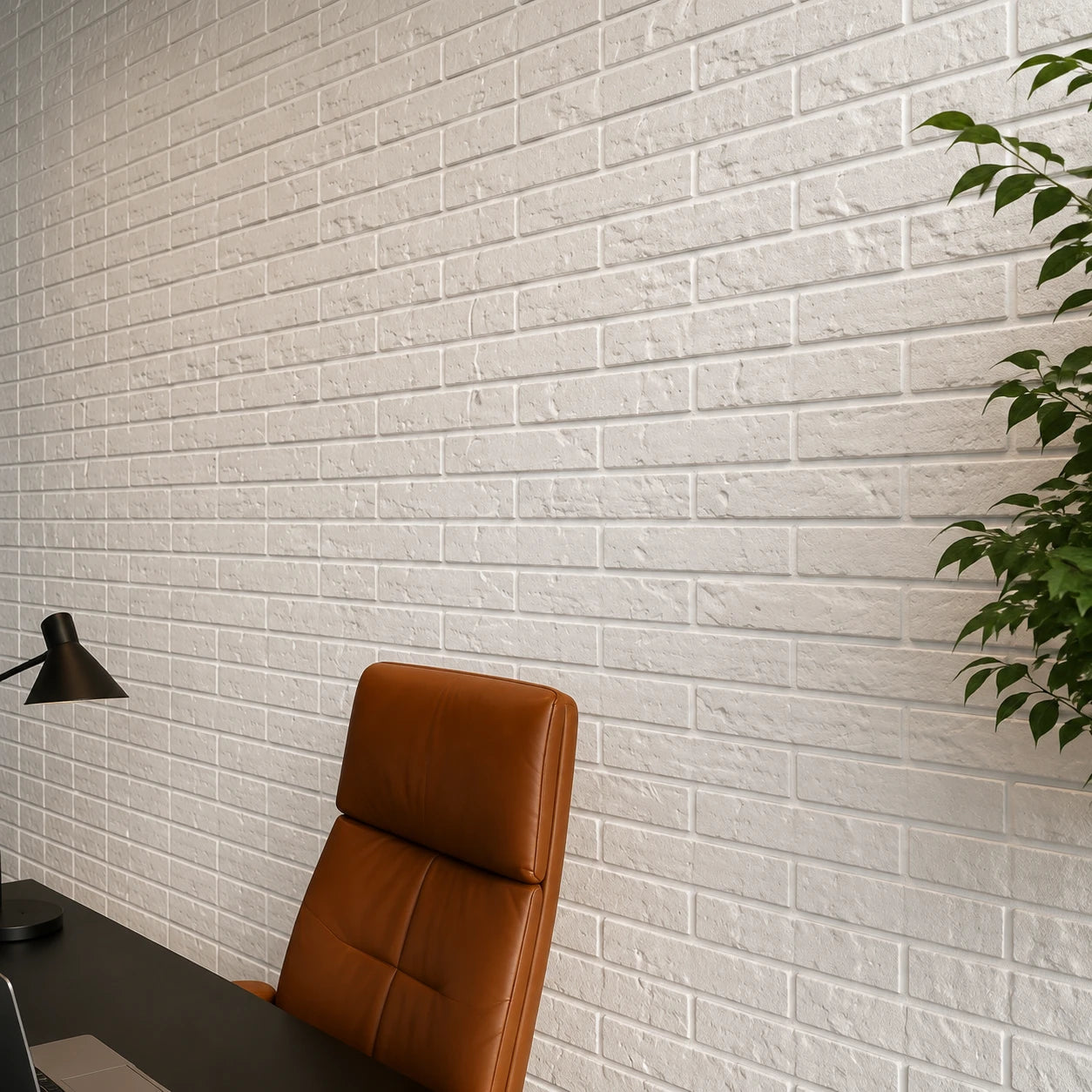 Close-up of white Old Brick 3D polystyrene wall panels showing their textured relief in a modern executive office.