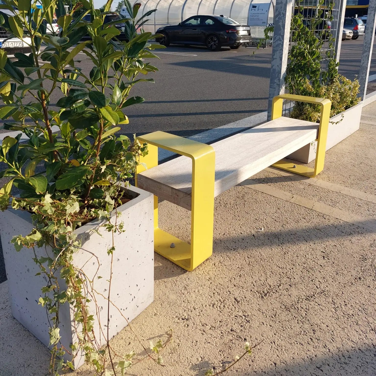 Outdoor Concrete Planters - Rectangle 50x120x50 cm in a parking lot next to a bench Decormania UK