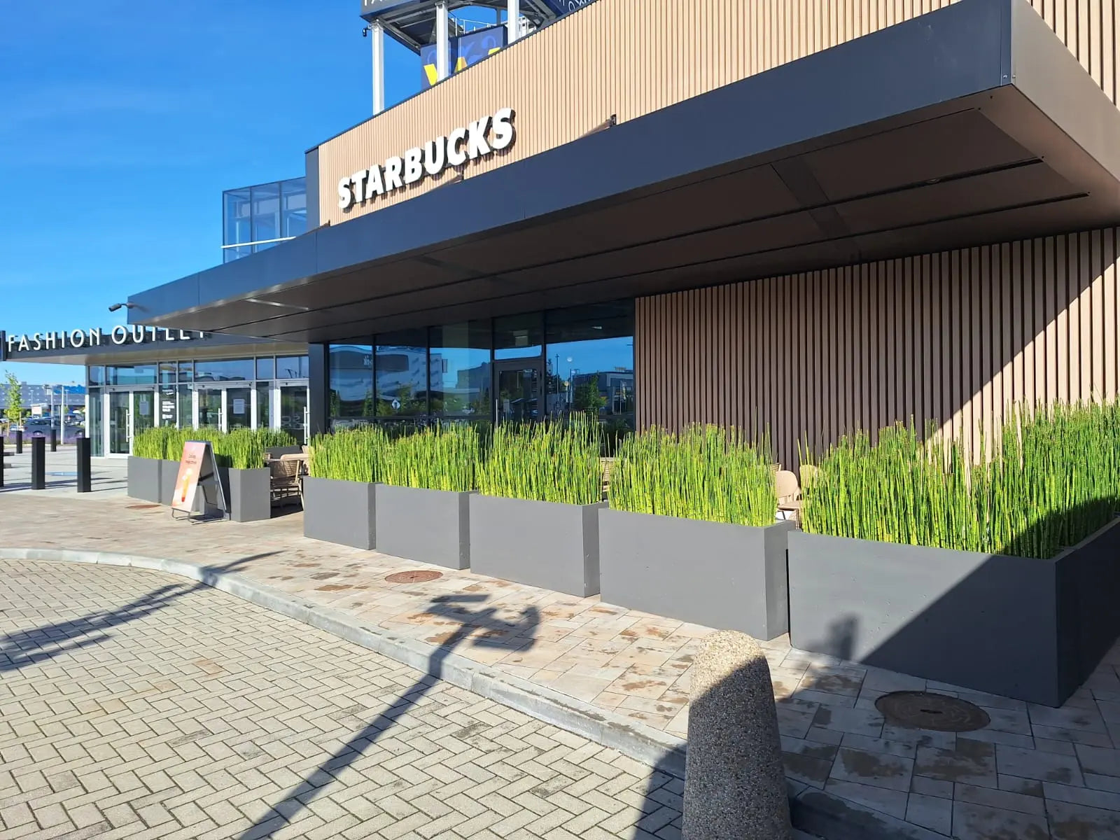 Outdoor Concrete Planters - Rectangle 50x120x50 cm in front of a starbucks Decormania UK