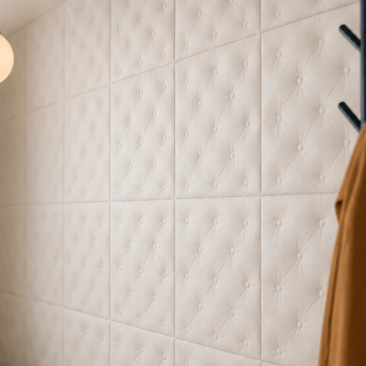 Close-up of white PILLOW 3D polystyrene wall panels showing the tufted relief, texture and module joints