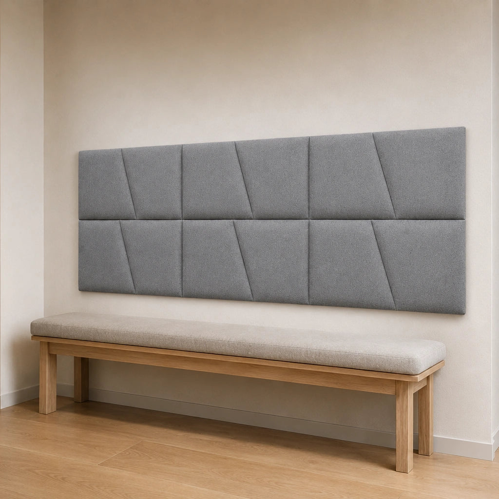 Angled view of a cream modular wall panel arranged in two rows above a sofa, showing its regular layout and geometric pattern