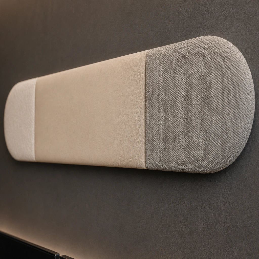 Close-up angled view of a beige and grey upholstered wall panel, highlighting its rounded ends, vertical seams, padded relief and contrasting fabric textures