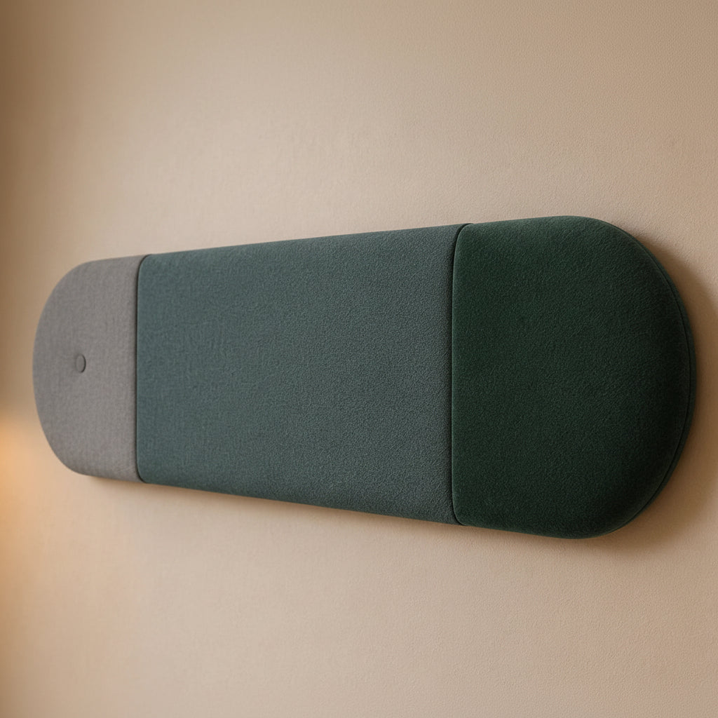 Close-up angled view of a three-section upholstered wall panel, highlighting its light grey and green colours, rounded relief, seams and textured fabric finish