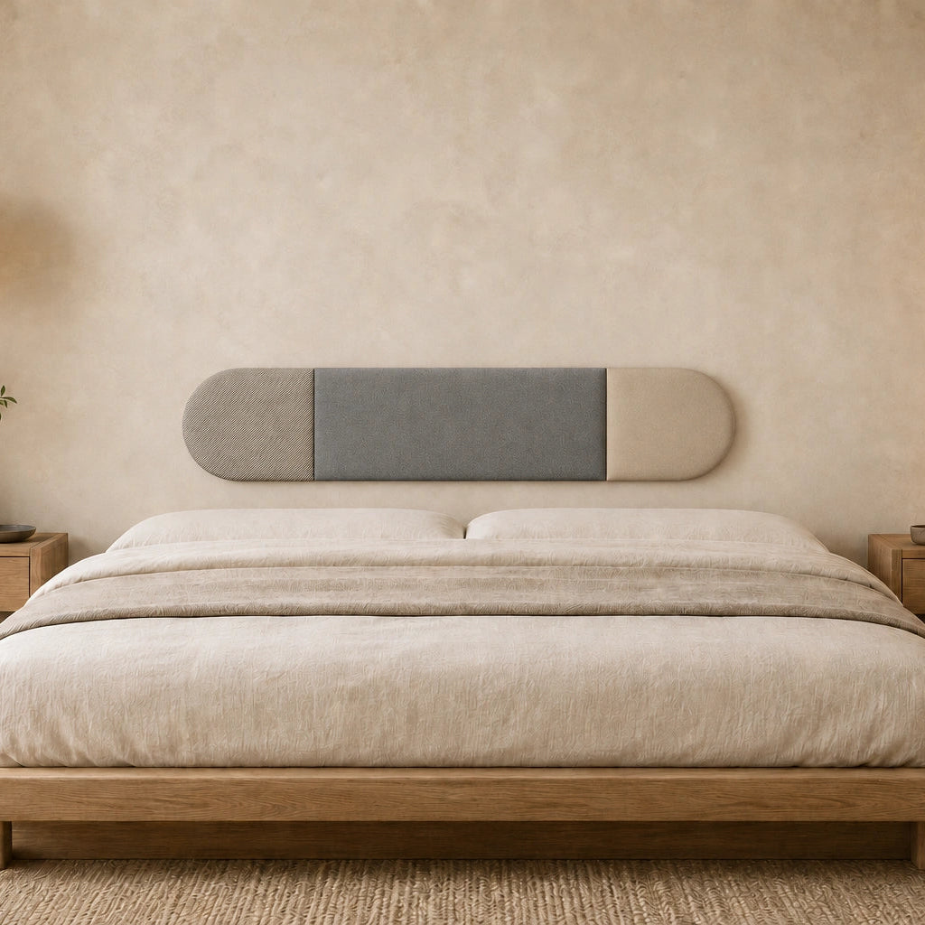 Front view of a three-section grey and beige upholstered wall panel displayed above a wooden bed in a warm, minimalist bedroom