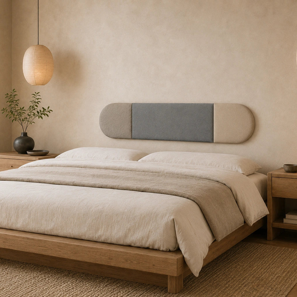 Angled view of a rounded grey and beige wall panel mounted above a bed in a calm, neutral bedroom with wooden furniture