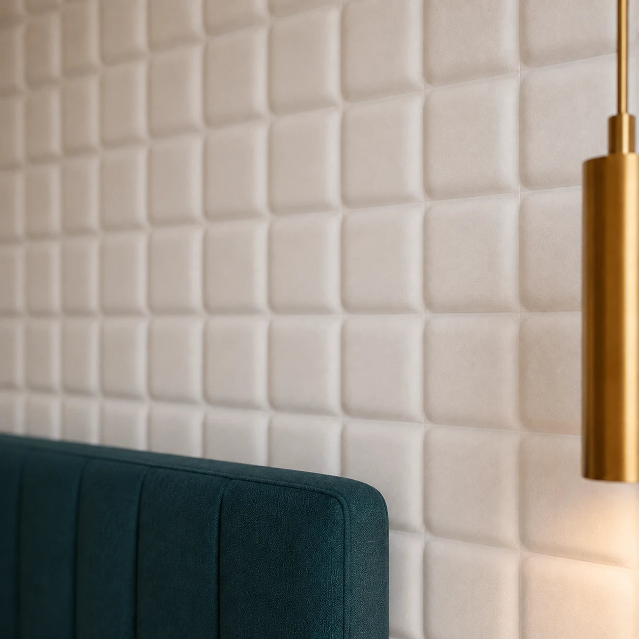 Close-up of white SQUARE 3D polystyrene wall panels with rounded relief, shown beside a teal headboard and brass pendant light
