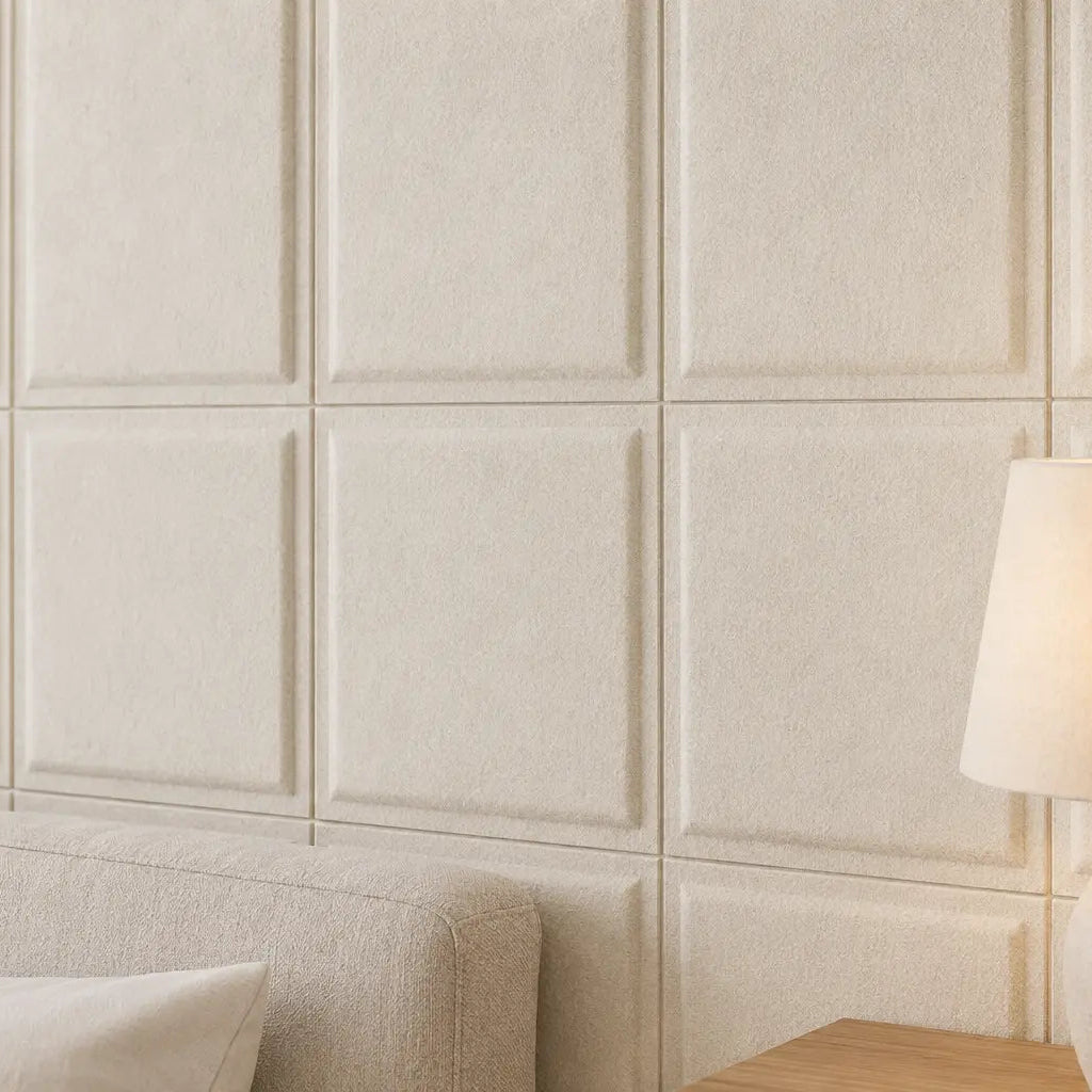 Close-up of cream Square Bold 3D acoustic felt wall panels beside a softly lit bedside lamp