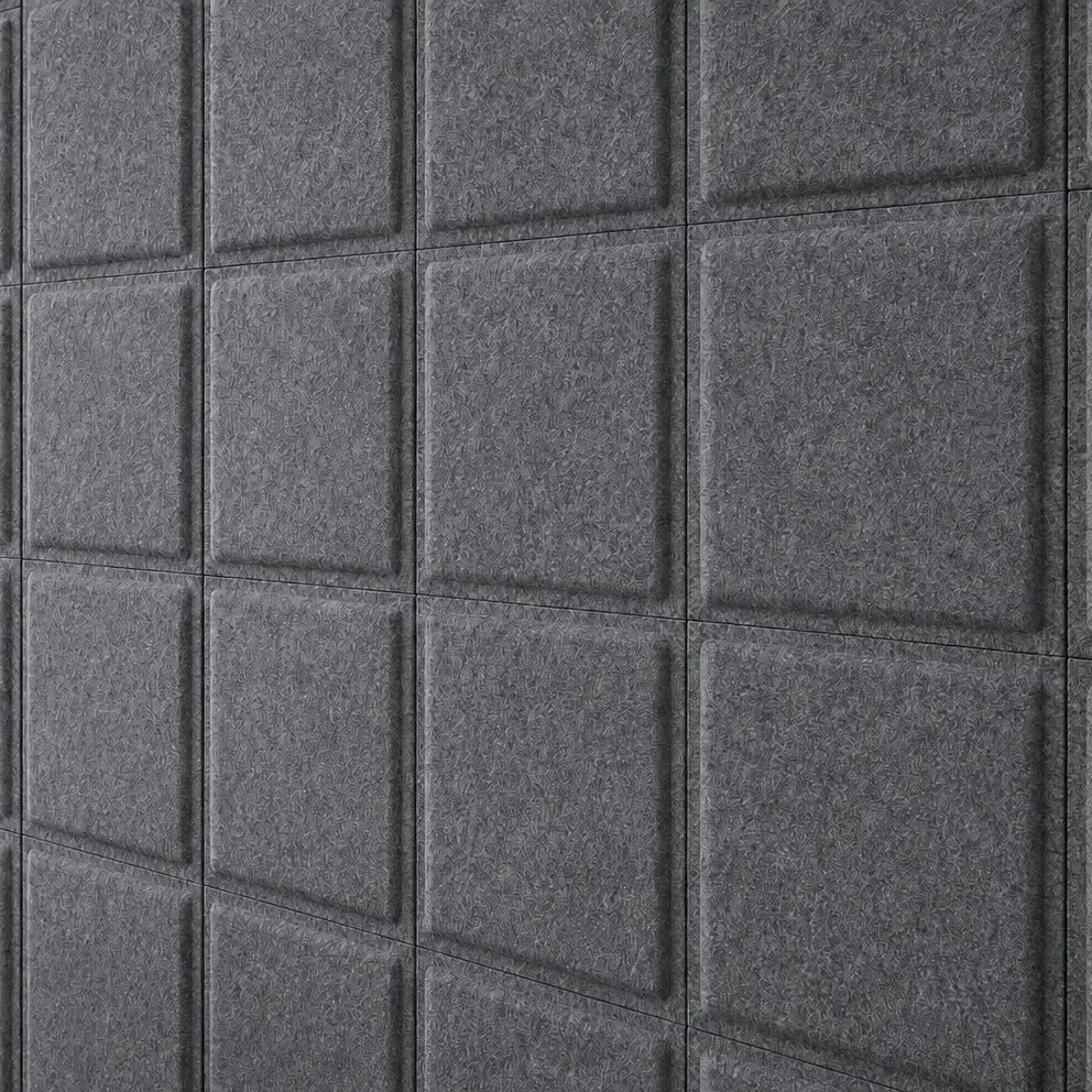 Close-up of grey Square Bold acoustic felt panels showing their textured surface and raised square design
