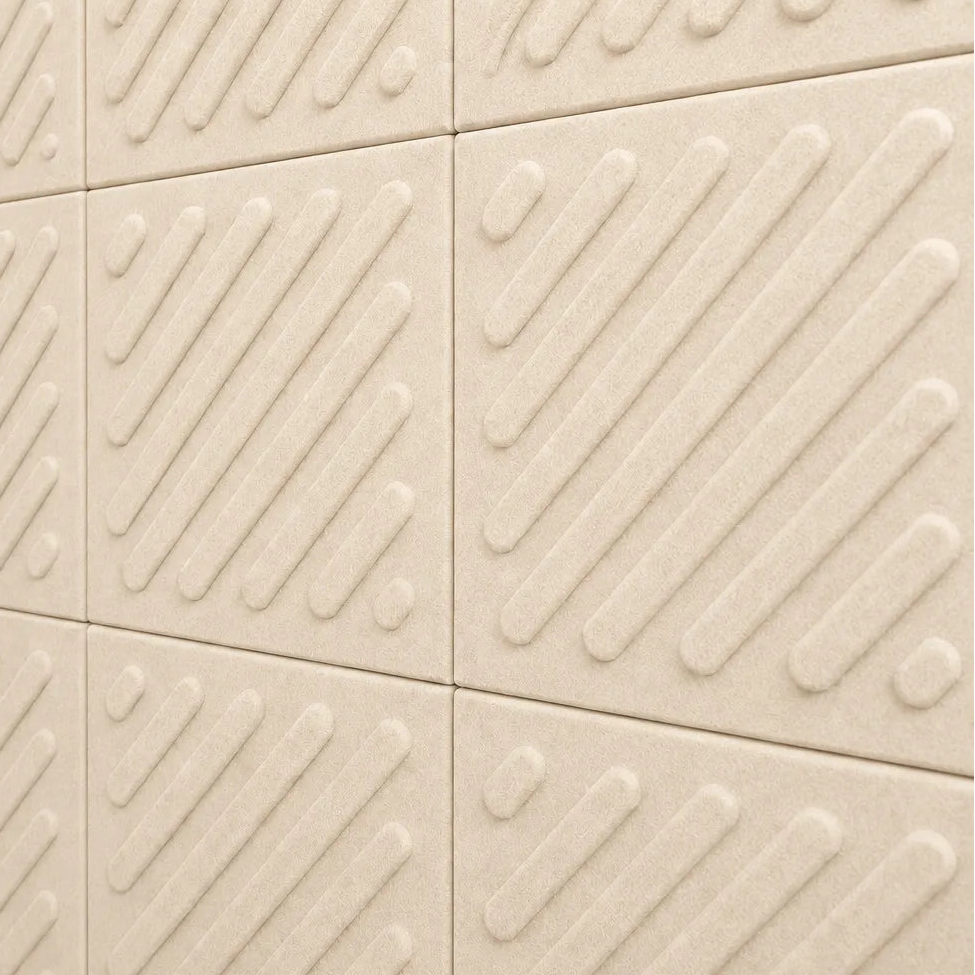 Close-up of cream acoustic felt wall panels highlighting the fibrous texture, raised relief and module connections