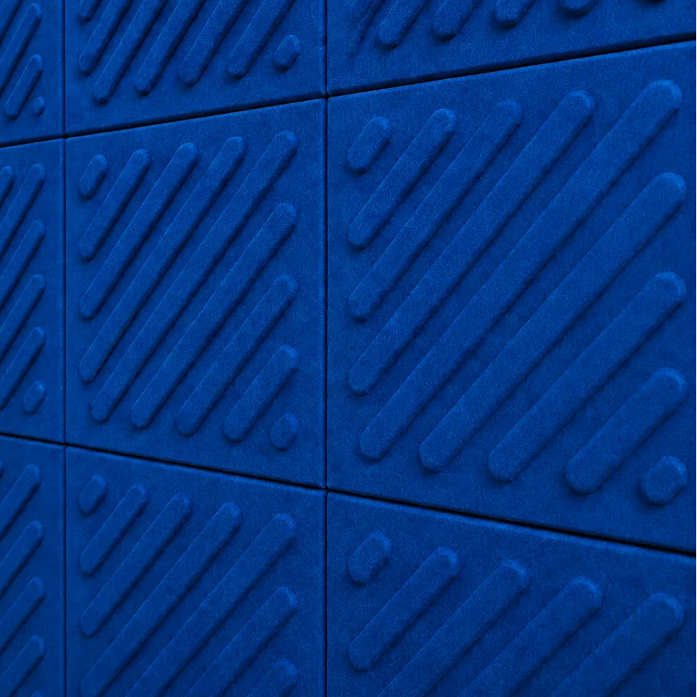 Close-up of indigo acoustic felt wall panels highlighting the fibrous texture, raised relief and module connections