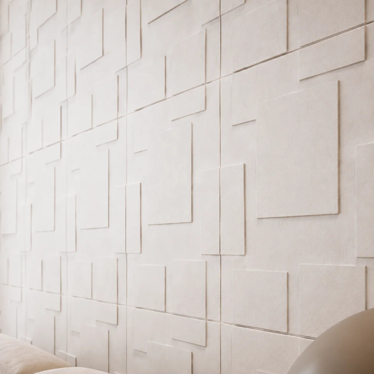 Close-up of white Squares gypsum 3D wall panels showing the layered rectangular relief and textured finish