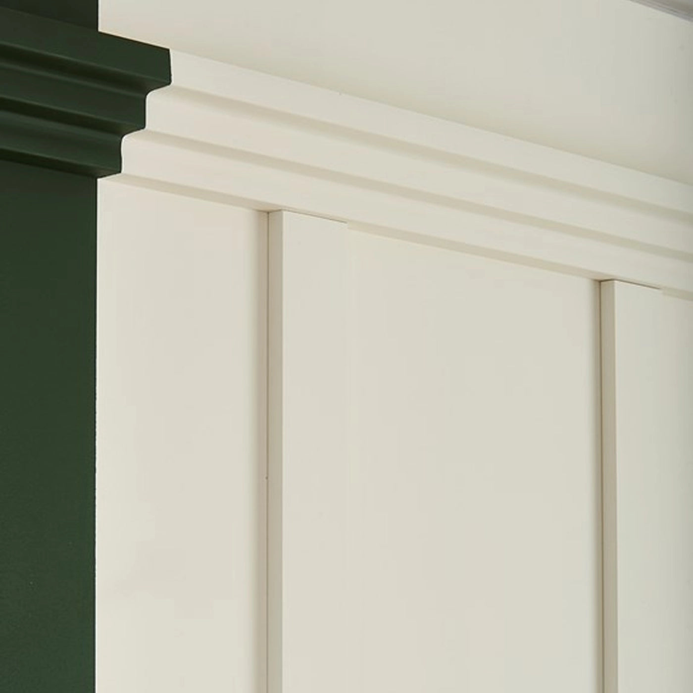 NOMASTYL® NMC 2m Ceiling Coving close-up on plain green and white wall Decormania UK