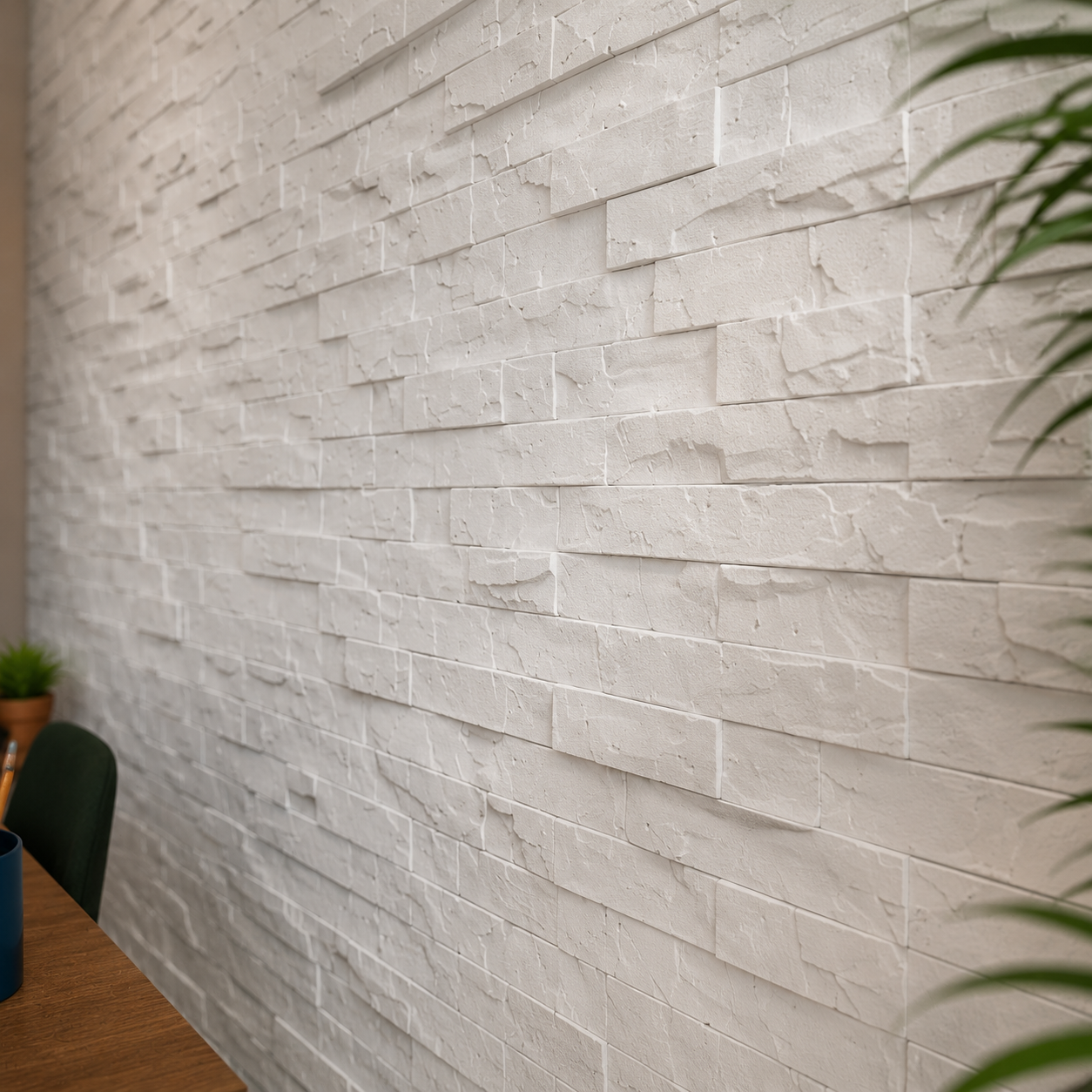 Close-up of white stone-effect 3D polystyrene wall panels showing the raised relief, textured surface and staggered joints