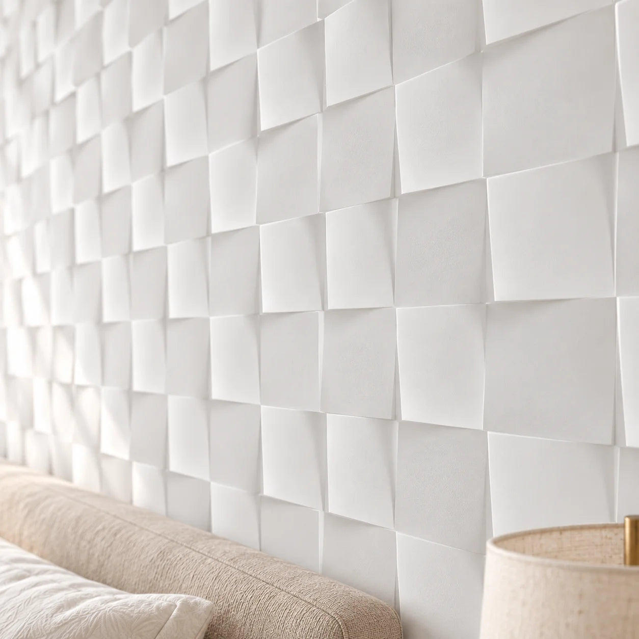 Close view of Square 3D gypsum wall panels showing geometric relief and matte white texture beside a bedroom lamp