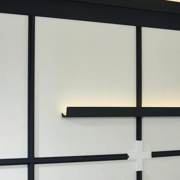 T40 WALLSTYL black decorative wall profiles used in a modern geometric wall composition with indirect lighting
