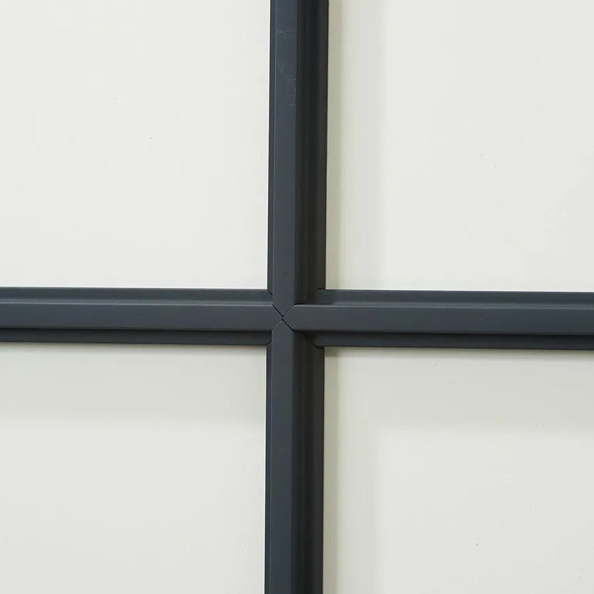 Close-up of T40 WALLSTYL black decorative mouldings joined in a precise geometric grid pattern