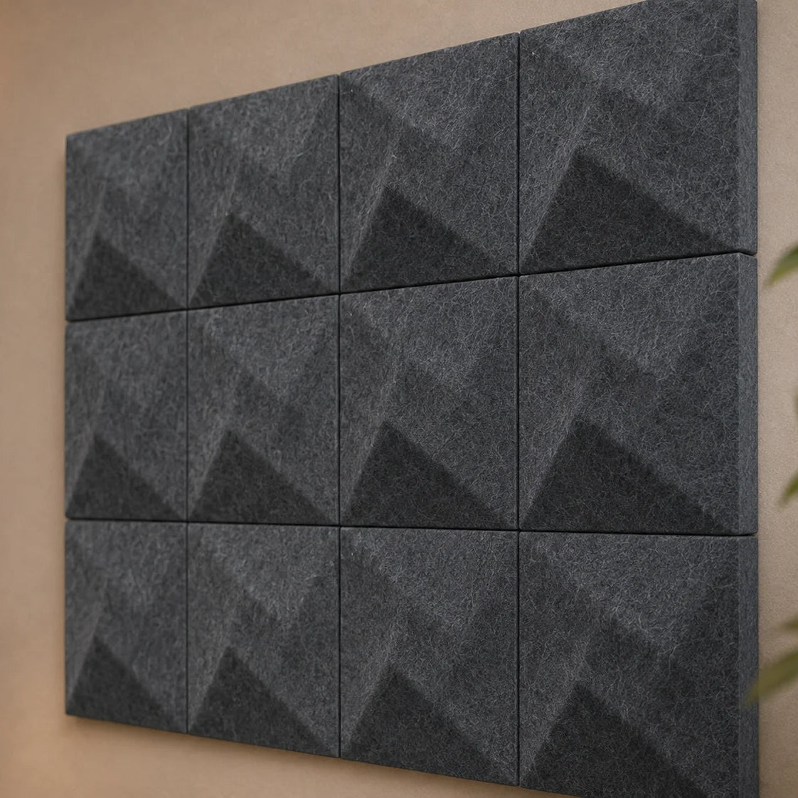 Angled view of grey TWIST acoustic panels in a cosy reading corner with natural wood and neutral furnishings