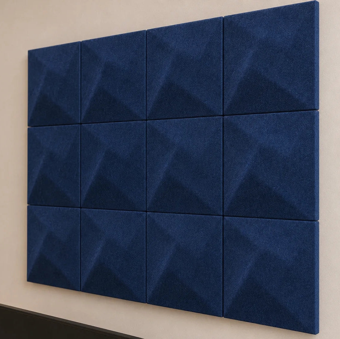 Close-up of navy square felt acoustic panels showing subtle Twist relief, even joints and textured fibres