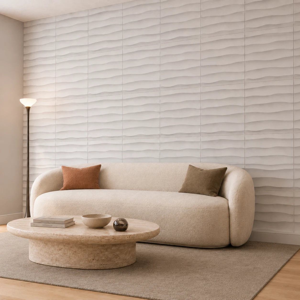 Angled view of a modern living room featuring white WAVES 3D wall panels, a cream sofa and sculptural stone table