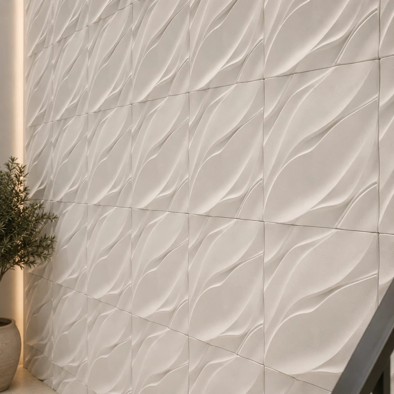 Close-up of white Waves gypsum 3D wall panels showing the flowing relief and textured finish