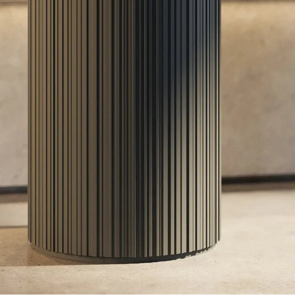 Close-up of dark ALLEGRETTO FLEX panels wrapped around a cylindrical column, showing vertical ribbed detailing
