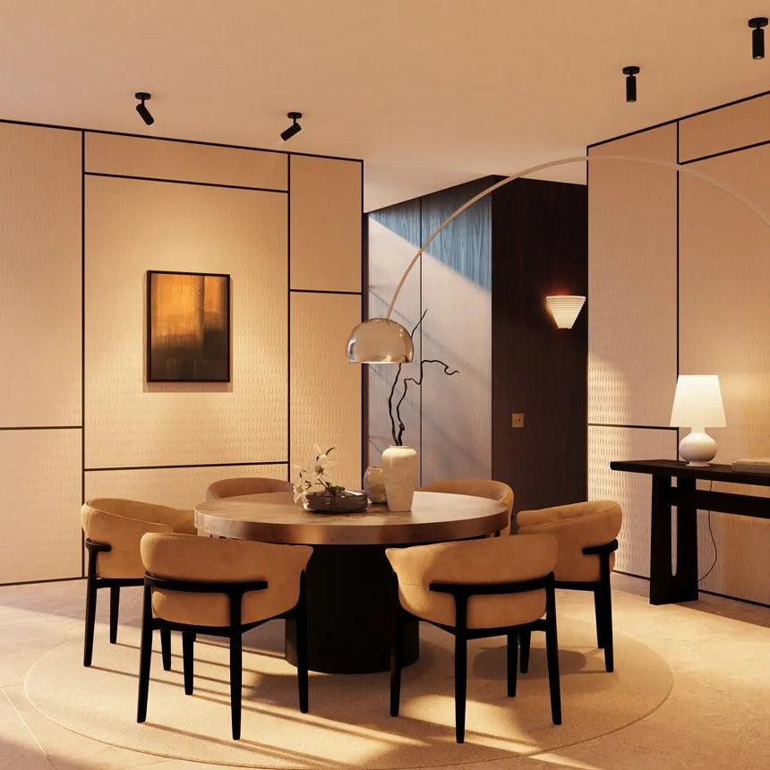 Cream BOHEMIA ARSTYL wall panels with black trim in a dining room with a round table and ochre chairs
