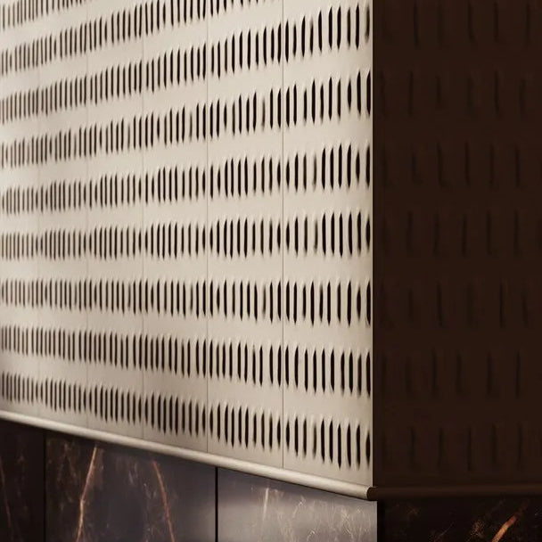 BOHEMIA ARSTYL wall panels meeting at a corner above dark marble, with side lighting highlighting the relief
